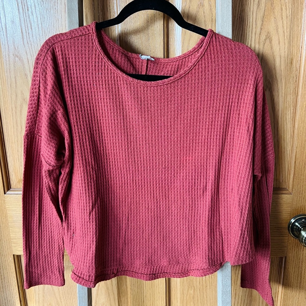 Red/pink sweater. No brand. Thinking size small. Cut tag off.